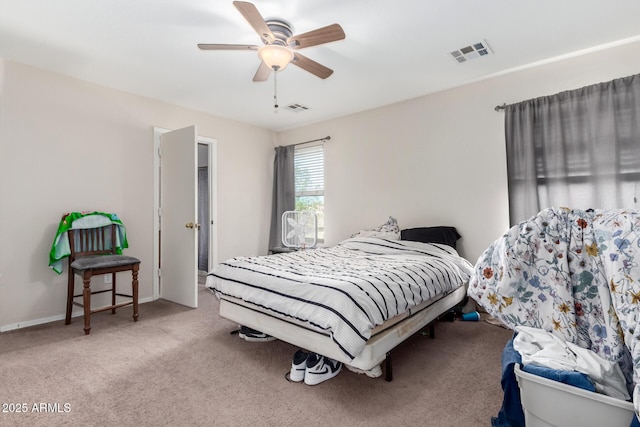 bedroom with ceiling fan and light carpet