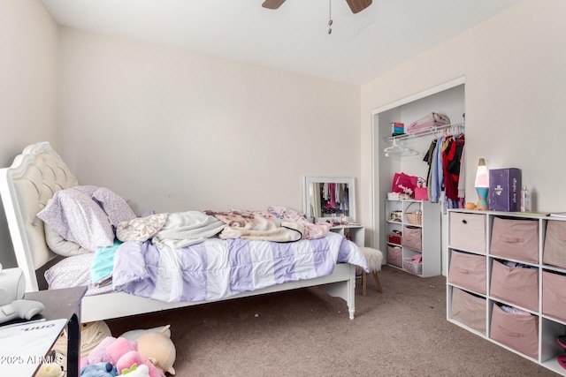 carpeted bedroom featuring ceiling fan and a closet