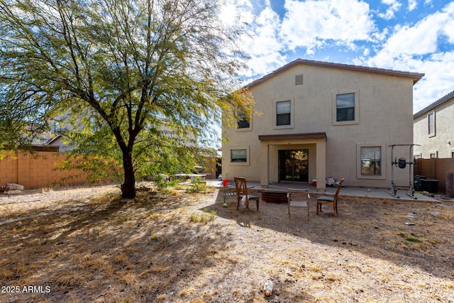 rear view of house featuring central AC and a patio