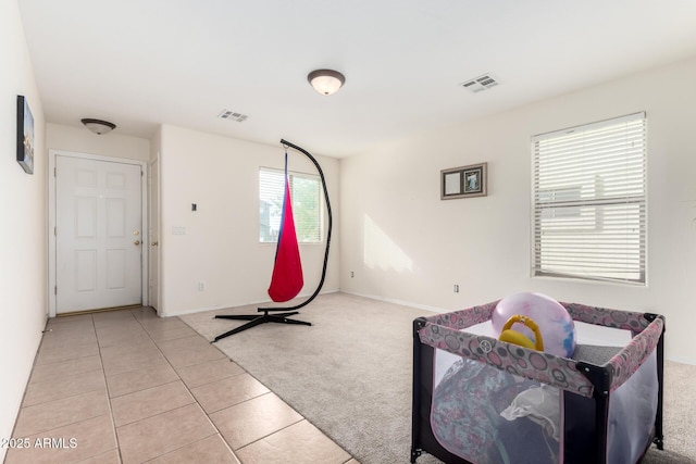 exercise room featuring light carpet