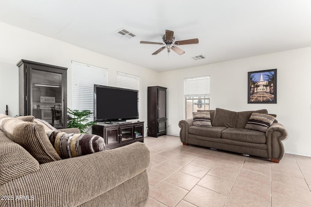 living room with ceiling fan and light tile patterned floors