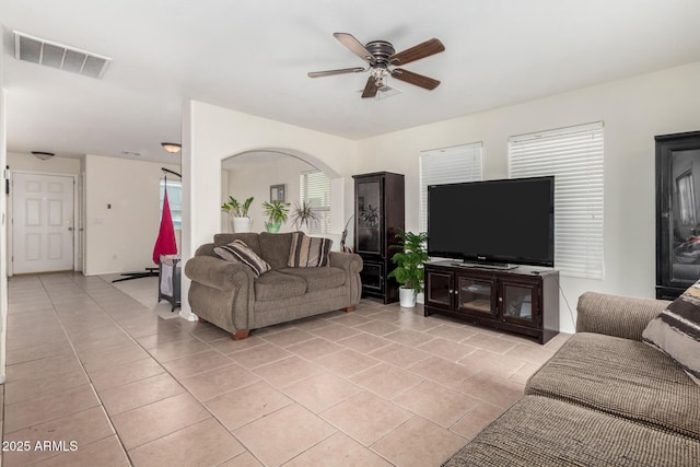 tiled living room with ceiling fan