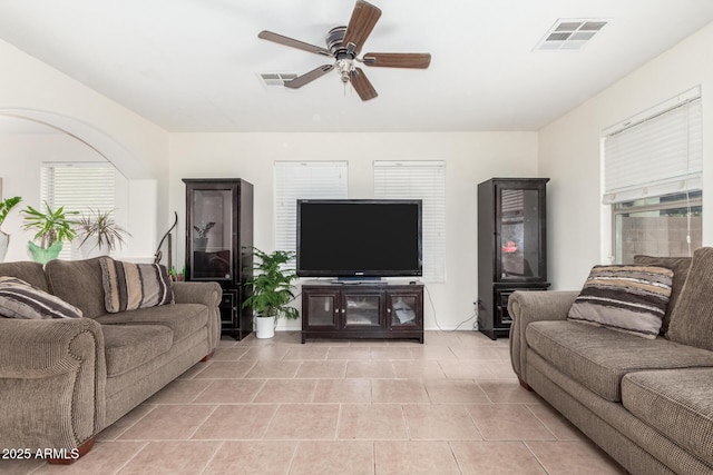 living room featuring plenty of natural light and ceiling fan