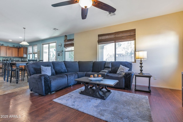 living room featuring dark hardwood / wood-style flooring and ceiling fan