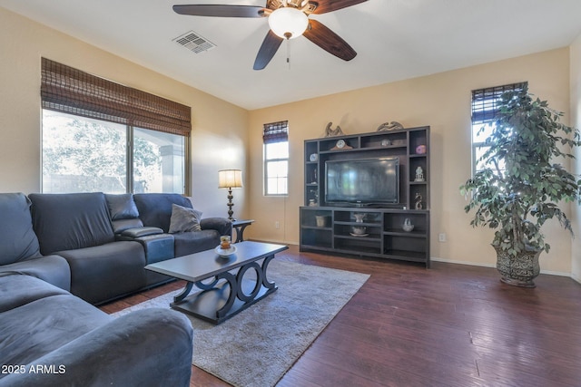 living room with dark hardwood / wood-style floors and ceiling fan