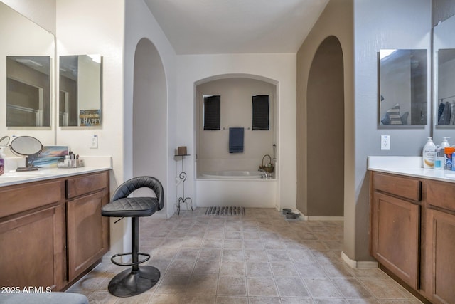 bathroom featuring vanity and a bath