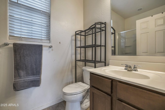 bathroom with tile patterned flooring, vanity, toilet, and a shower with shower door