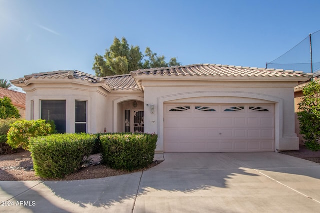 mediterranean / spanish home with a garage