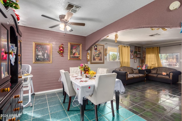 dining room with ceiling fan and a textured ceiling