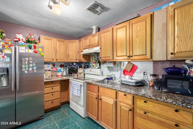 kitchen with a textured ceiling, white electric range, dark stone counters, stainless steel refrigerator with ice dispenser, and sink