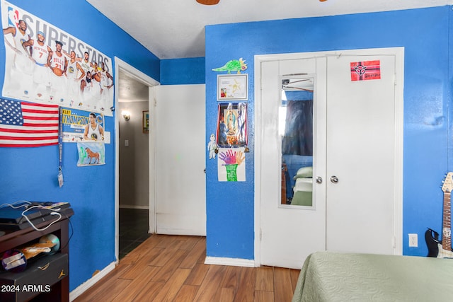 bedroom with wood-type flooring and a closet