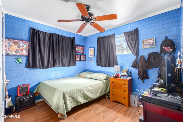 bedroom with hardwood / wood-style flooring and ceiling fan