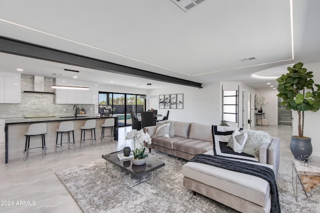 living room with sink and light tile flooring