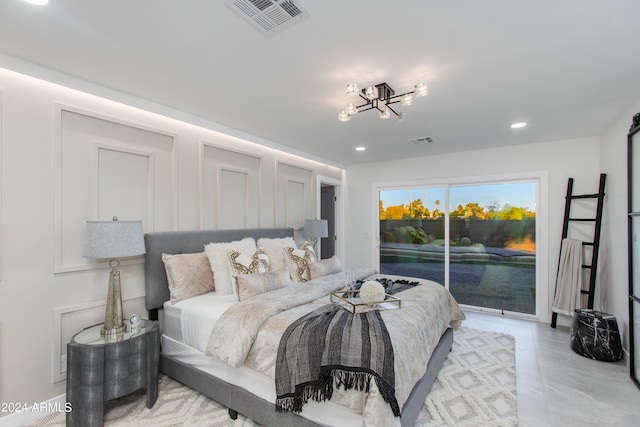 bedroom with light tile floors and access to exterior