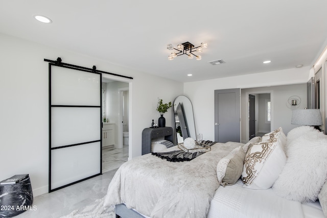 tiled bedroom with a barn door and ensuite bath