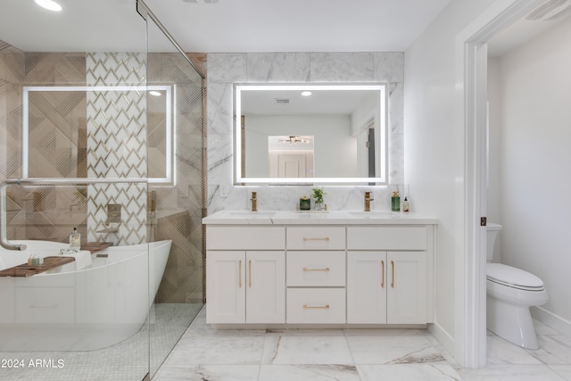 bathroom featuring tile walls, tile floors, toilet, and dual bowl vanity