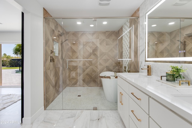 bathroom with tile walls, tile floors, an enclosed shower, and double sink vanity