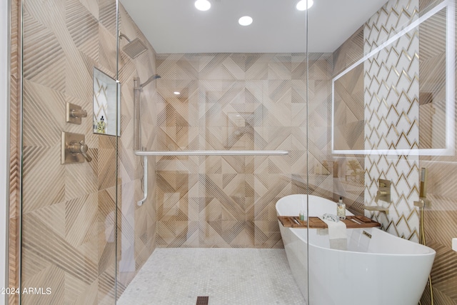 bathroom with separate shower and tub and tile walls