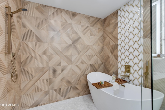 bathroom with a bath and tile walls