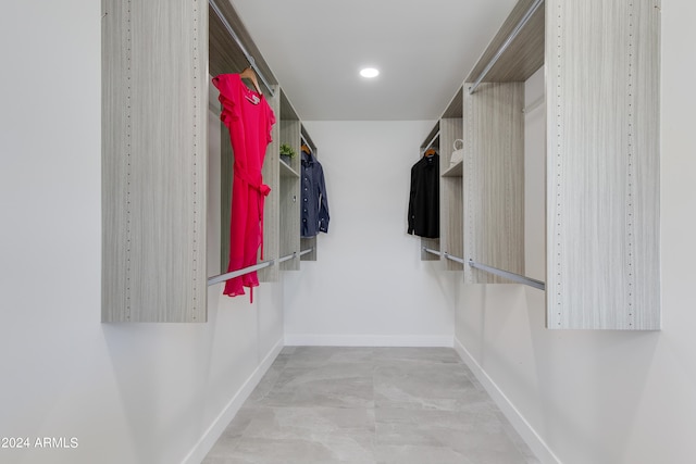 walk in closet with tile floors