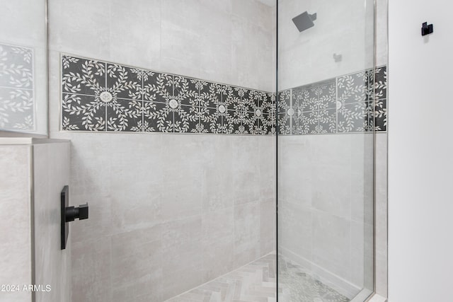 bathroom featuring a shower with shower door