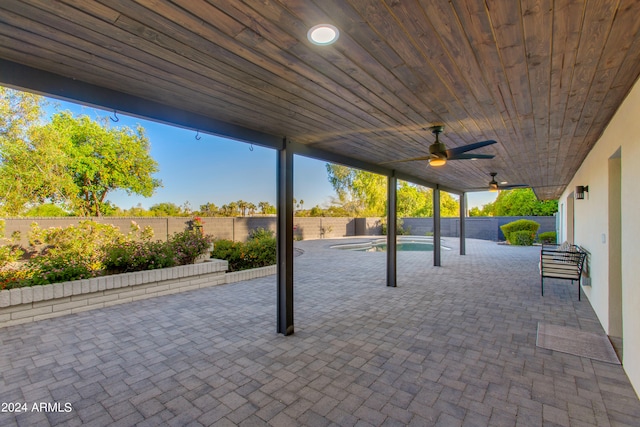 view of patio featuring ceiling fan and a fenced in pool