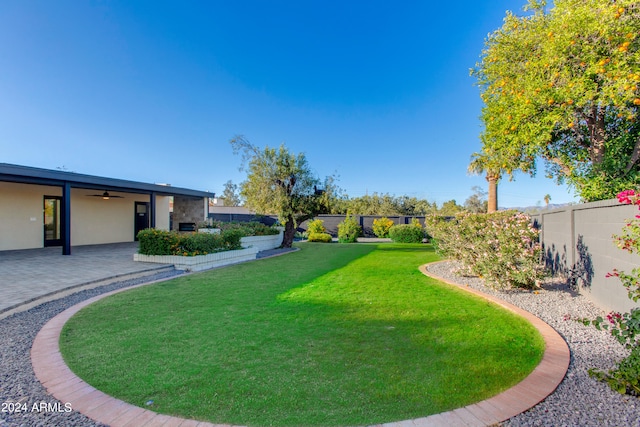 view of home's community featuring a lawn and a patio area