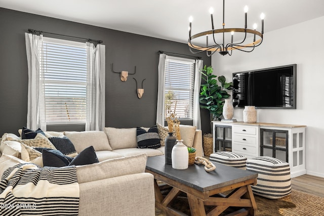 living room featuring plenty of natural light, a chandelier, and hardwood / wood-style flooring