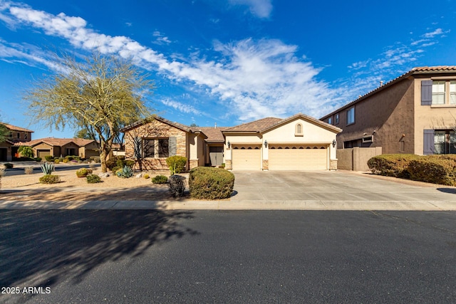 mediterranean / spanish-style house featuring concrete driveway, an attached garage, a tiled roof, and stucco siding