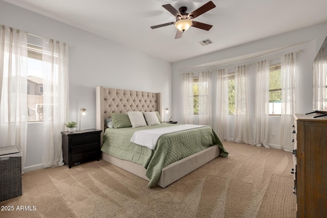 carpeted bedroom with ceiling fan and lofted ceiling