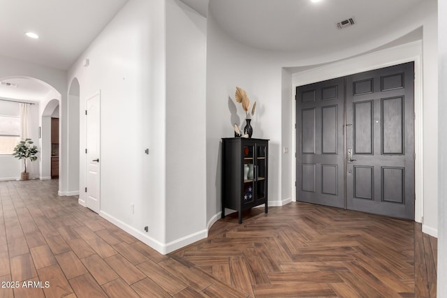 corridor featuring dark parquet flooring