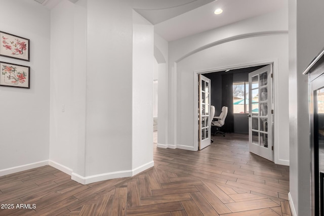 hall with dark parquet floors and french doors