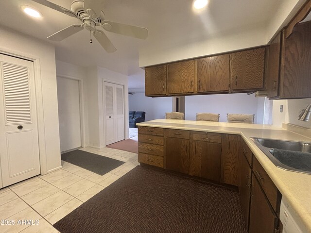 4537 E Emelita Ave, Mesa, AZ 85206 - kitchen with a sink, ceiling fan, light countertops, light tile patterned floors, and dark brown cabinets