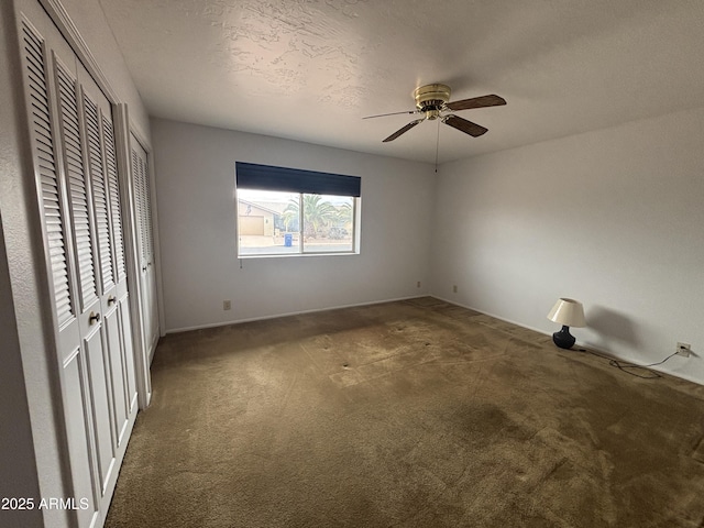 4537 E Emelita Ave, Mesa, AZ 85206 - unfurnished bedroom with two closets, carpet floors, ceiling fan, and baseboards