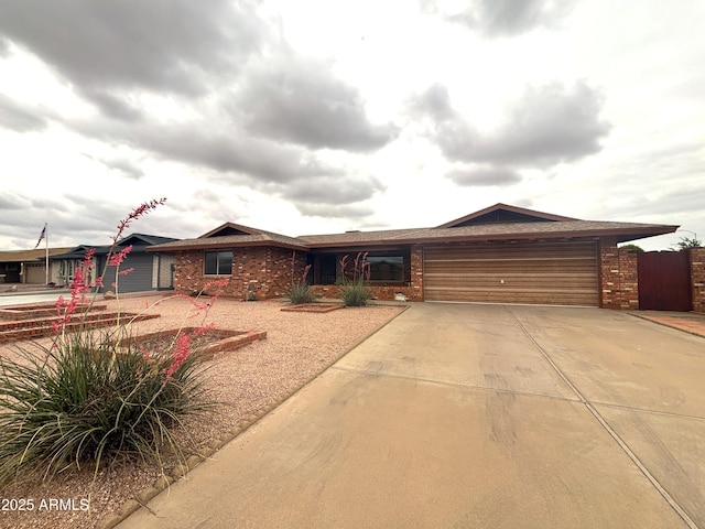 4537 E Emelita Ave, Mesa, AZ 85206 - ranch-style home featuring concrete driveway, an attached garage, and brick siding