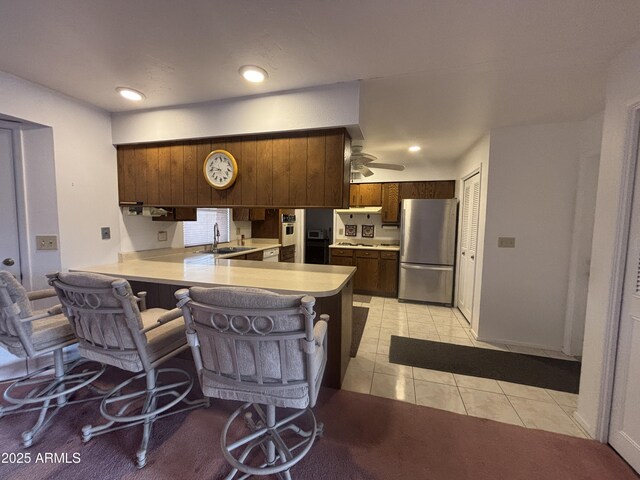 4537 E Emelita Ave, Mesa, AZ 85206 - kitchen featuring freestanding refrigerator, light tile patterned floors, a sink, a peninsula, and light countertops