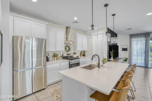 17976 W Ashley Dr, Goodyear, AZ 85338 - kitchen with appliances with stainless steel finishes, wall chimney exhaust hood, light tile patterned flooring, white cabinets, and recessed lighting