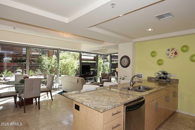 kitchen featuring light stone counters, a peninsula, a sink, visible vents, and dishwasher