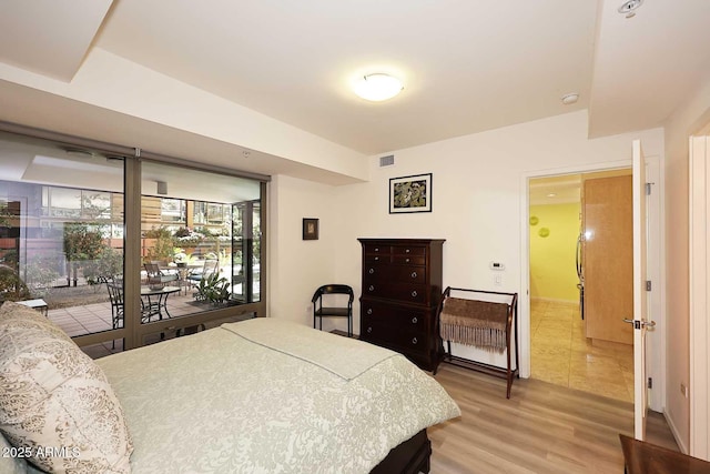 bedroom featuring light wood-type flooring and visible vents