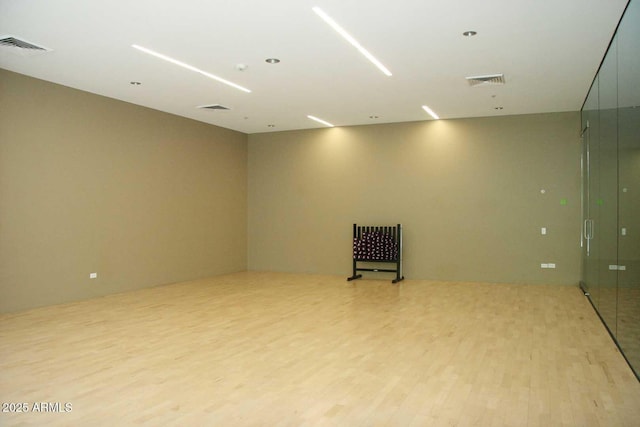 spare room with light wood-type flooring and visible vents