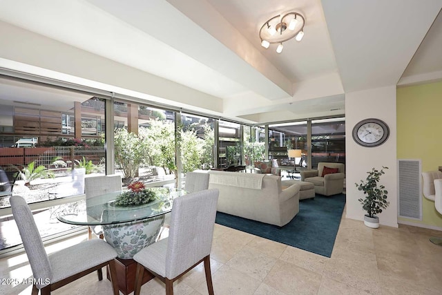 dining area with beamed ceiling and visible vents