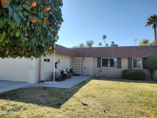 ranch-style home with an attached garage, a front yard, mansard roof, and roof with shingles