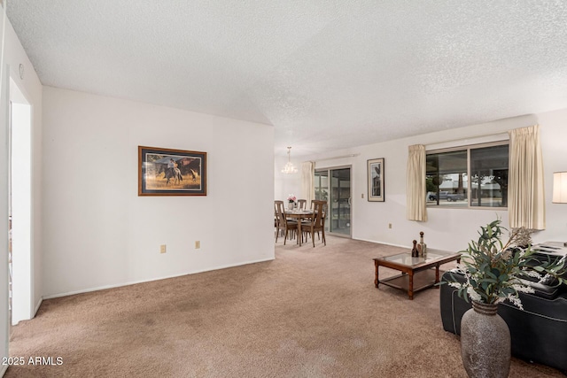 living room with a textured ceiling and light colored carpet