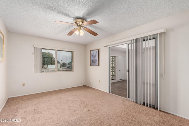 unfurnished bedroom featuring carpet flooring, ceiling fan, a textured ceiling, and baseboards