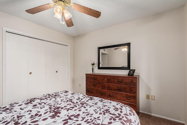 bedroom featuring carpet floors, a closet, a ceiling fan, a textured ceiling, and baseboards