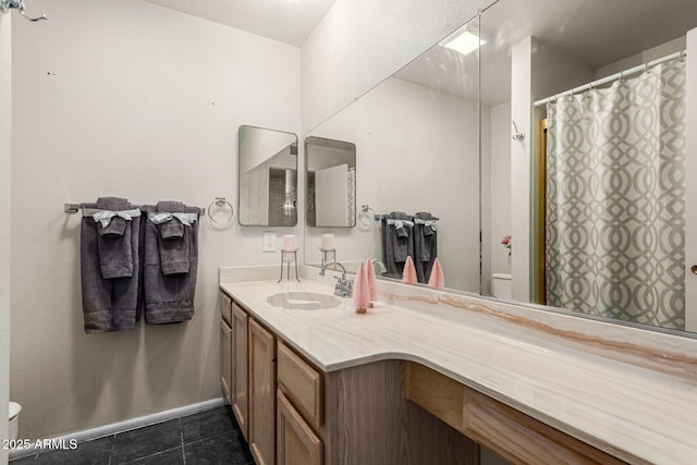 bathroom featuring toilet, curtained shower, tile patterned flooring, and vanity