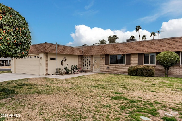 ranch-style home with mansard roof, a shingled roof, an attached garage, a front yard, and driveway