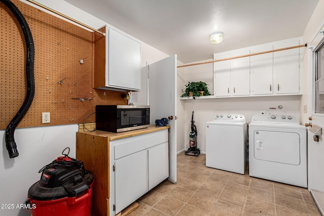 laundry area with cabinet space and independent washer and dryer