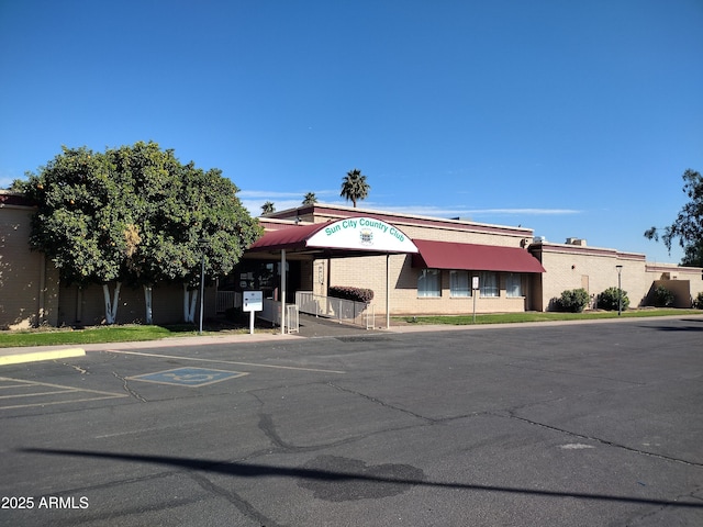 view of building exterior with uncovered parking