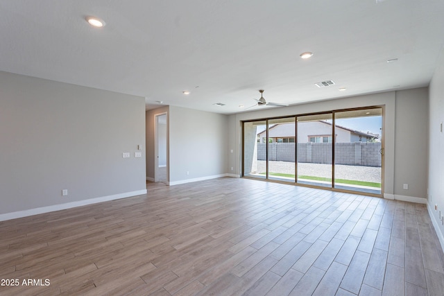 empty room featuring a ceiling fan, light wood-style floors, baseboards, and recessed lighting